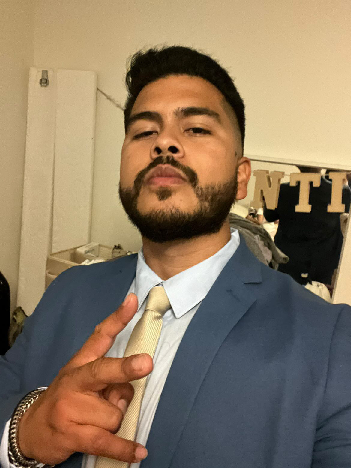 A person named Jose in a blue suit and yellow tie posing above a 16 ounce jar of Banana Cream Pie yogurt
